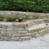 Steinmauer Garten mit Sitzplatz und Bepflanzung am Hang - Garten planen und Gartenbau vom Maschinenring